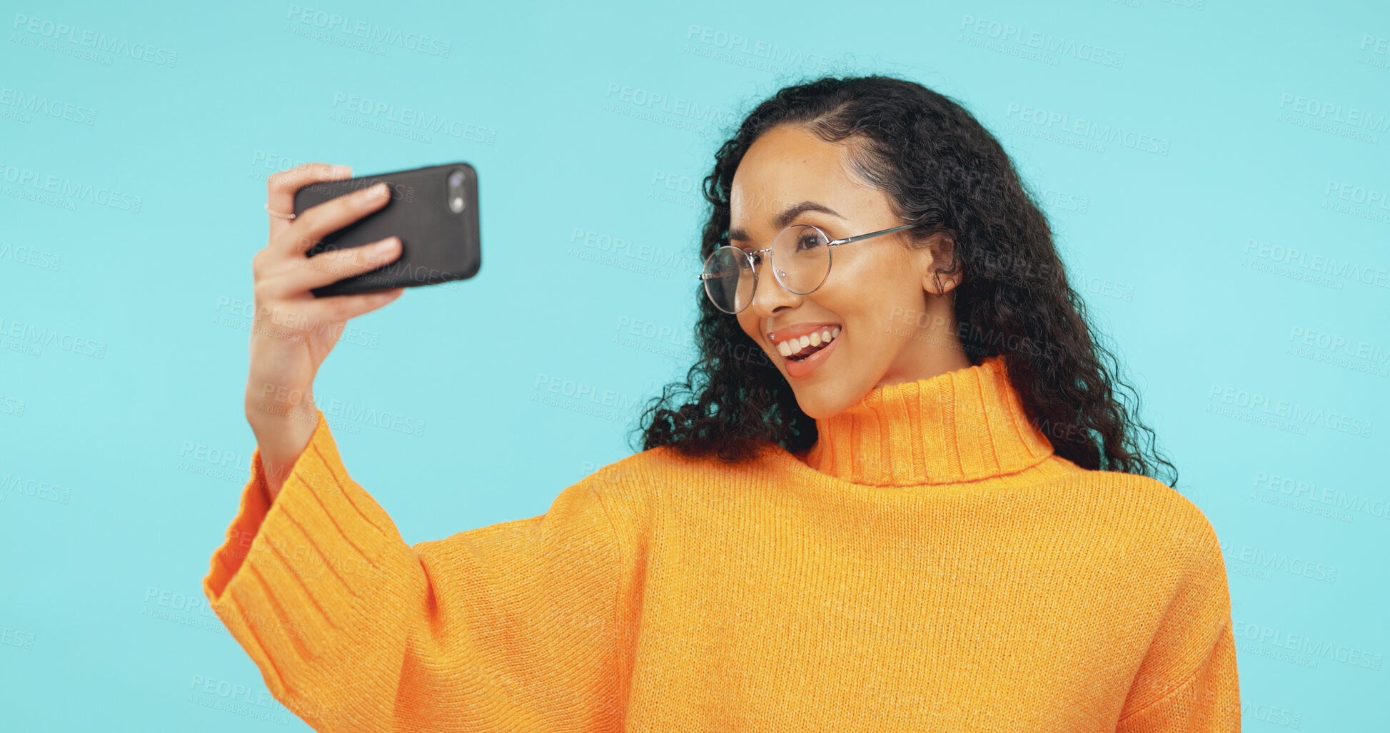 Buy stock photo Happy, glasses and woman in studio with selfie for social media, online post and content creator. Phone, influencer and person with smile for profile picture, photo and memory on blue background