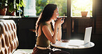 Laptop, coffee and woman in cafe with freelance career for restaurant review on dining blog. Technology, warm beverage and female hospitality critic with computer for article with diner website.