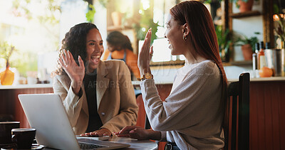 Buy stock photo Creative, high five and businesswomen with laptop in coffee shop, teamwork and happy for ad success. Cafe, brand manager and celebration for campaign performance, digital marketing and remote work