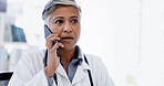 Hospital, phone call and mature doctor talking for telehealth, virtual consulting or discussion. Healthcare, clinic and woman on smartphone for connection, contact or conversation for medical service