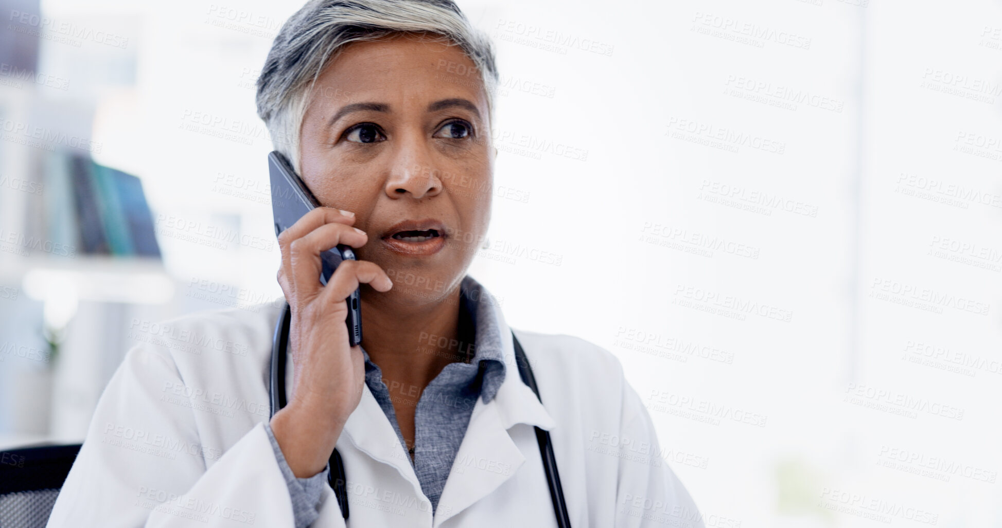 Buy stock photo Hospital, phone call and mature doctor talking for telehealth, virtual consulting or discussion. Healthcare, clinic and woman on smartphone for connection, contact or conversation for medical service