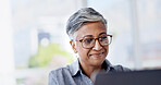 Reading, glasses and happy woman with laptop in business, research and financial analysis on website. Office, bookkeeper and mature person with tech for tax preparation, online and smile for info