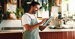 Typing tablet and man in cafe, smile and service for online order, barista and startup website. Happiness, entrepreneur or person in restaurant, tech for inventory or planning menu with hospitality
