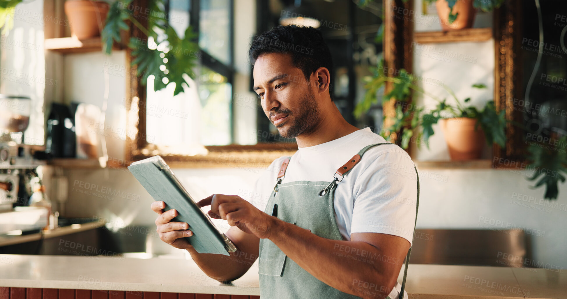 Buy stock photo Typing, tablet and man in cafe, internet or service for online order, hospitality or startup website. Barista, entrepreneur or person in restaurant, tech for inventory or planning menu to check price