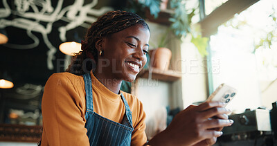 Buy stock photo Waitress, woman and text message in cafe with phone, smile and check notification for online order. Happy, black person and scroll in restaurant with tech, social media or mobile app for hospitality.