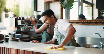 Buy stock photo Cleaning, cloth and counter with man in coffee shop for maintenance of small business startup. Hospitality, hygiene and wipe with people in restaurant cafe to disinfect surface for sanitizing routine