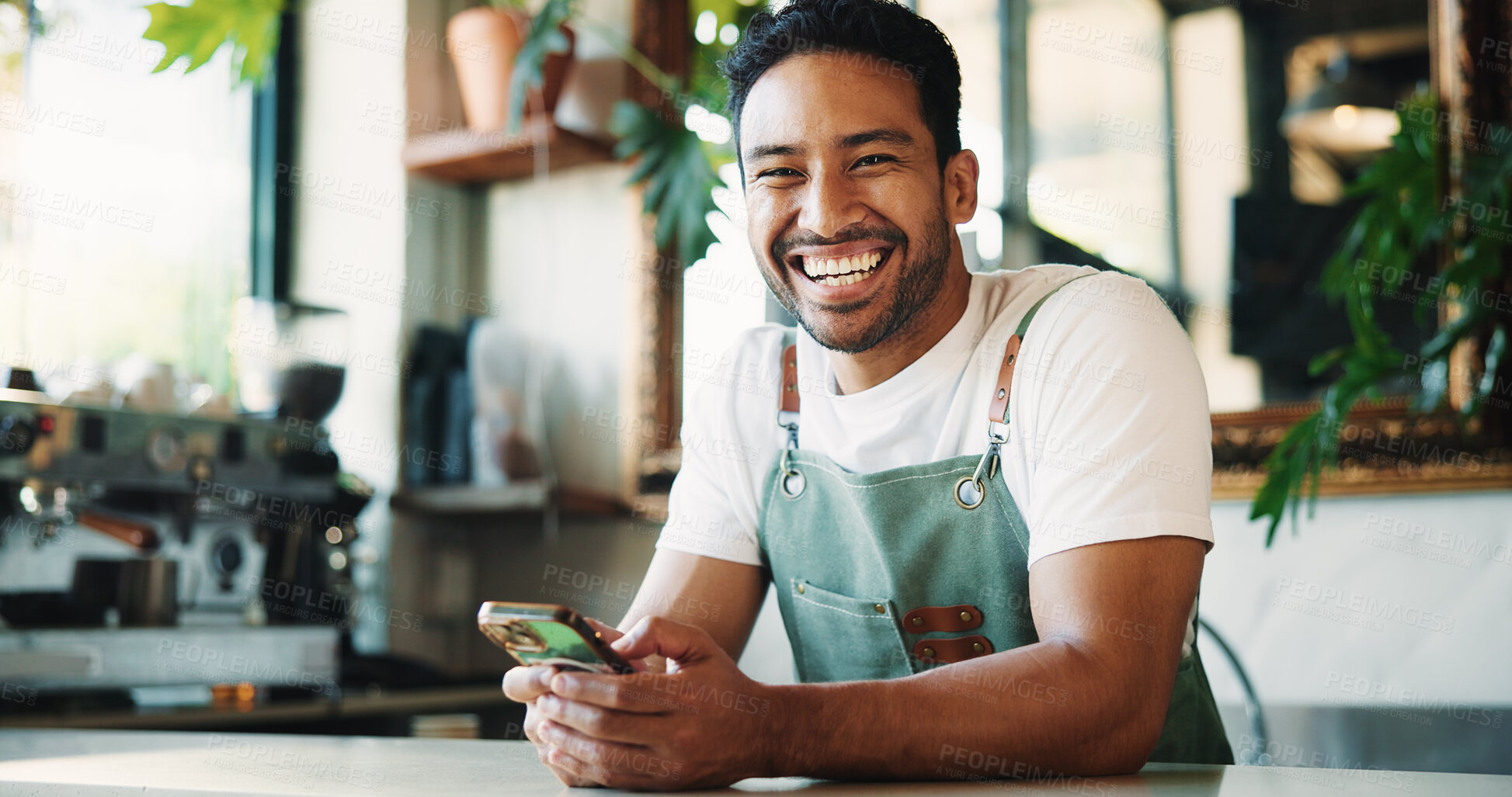 Buy stock photo Message, portrait and barista in cafe with phone, chat or social media comment on work break. Texting, happy or male person with tech, restaurant review or online communication for networking.