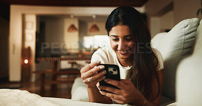 Buy stock photo Relax, reading and phone with woman on sofa in home for communication, social media and smile. Contact, online chat and connection with person and mobile in living room of apartment for app and post