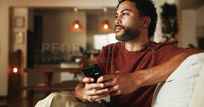 Buy stock photo Phone, relax and thinking with man on sofa in home for communication, social media and contact. Virtual chat, connection and networking app with person in apartment for news, update and idea