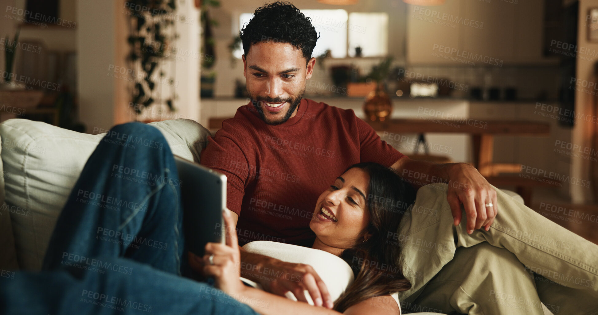 Buy stock photo Happy couple, relax and tablet on sofa with bonding, streaming or connection with funny video in home. People, partner and relationship with tech, application or film subscription on web at apartment