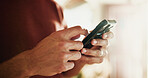 Phone, texting and hands with man in home for communication, social media and contact. Virtual chat, connection and networking app with male person in apartment for news, update and online post