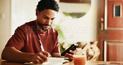 Buy stock photo Writing, notes and man with smartphone in house, online and planning for content creation on website. Happy, editor and social media video schedule with journal, remote work and person with mobile