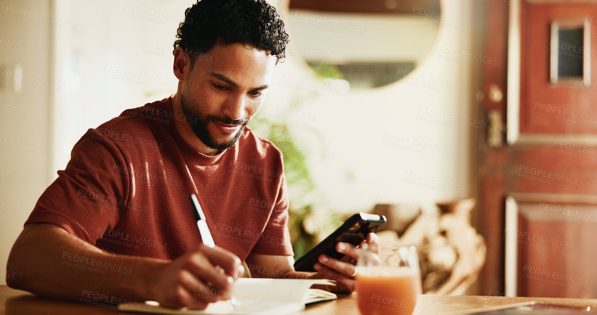 Buy stock photo Writing, notes and man with smartphone in house, online and planning for content creation on website. Happy, editor and social media video schedule with journal, remote work and person with mobile