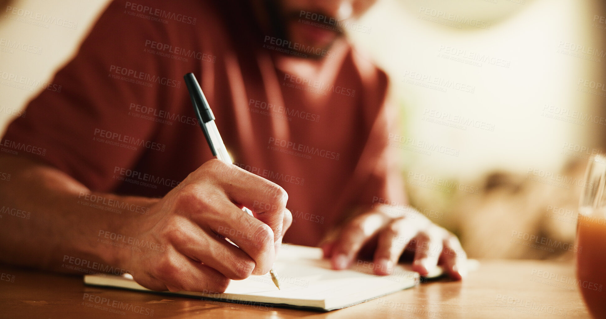 Buy stock photo Man, writing and hands with book in home for schedule, planning or calendar reminder. Male person, freelancer or remote work with diary or notebook for daily tasks, agenda or ideas on desk in house
