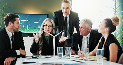 Buy stock photo Business, people and meeting with windmill in office for planning, discussion and renewable energy. Team, talking and pitch with wind turbine prototype, eco-friendly design and electricity innovation