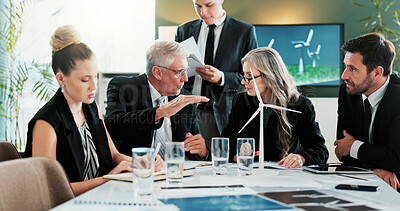 Buy stock photo Business, people and talking with windmill in meeting for planning, discussion and renewable energy. Team, pitch and office with wind turbine prototype, eco-friendly design and electricity innovation