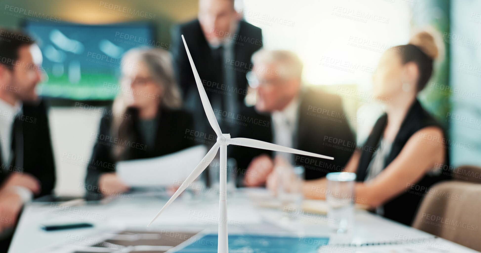 Buy stock photo Business, people and meeting with windmill prototype for planning, discussion and renewable energy. Team, talking or 3d model of wind turbine structure, eco-friendly design and electricity innovation