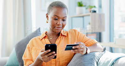 Buy stock photo Happy woman, home and online shopping with credit card, phone and payment on website in living room. Digital, purchase and black person with mobile for discount deal, ecommerce and order in house