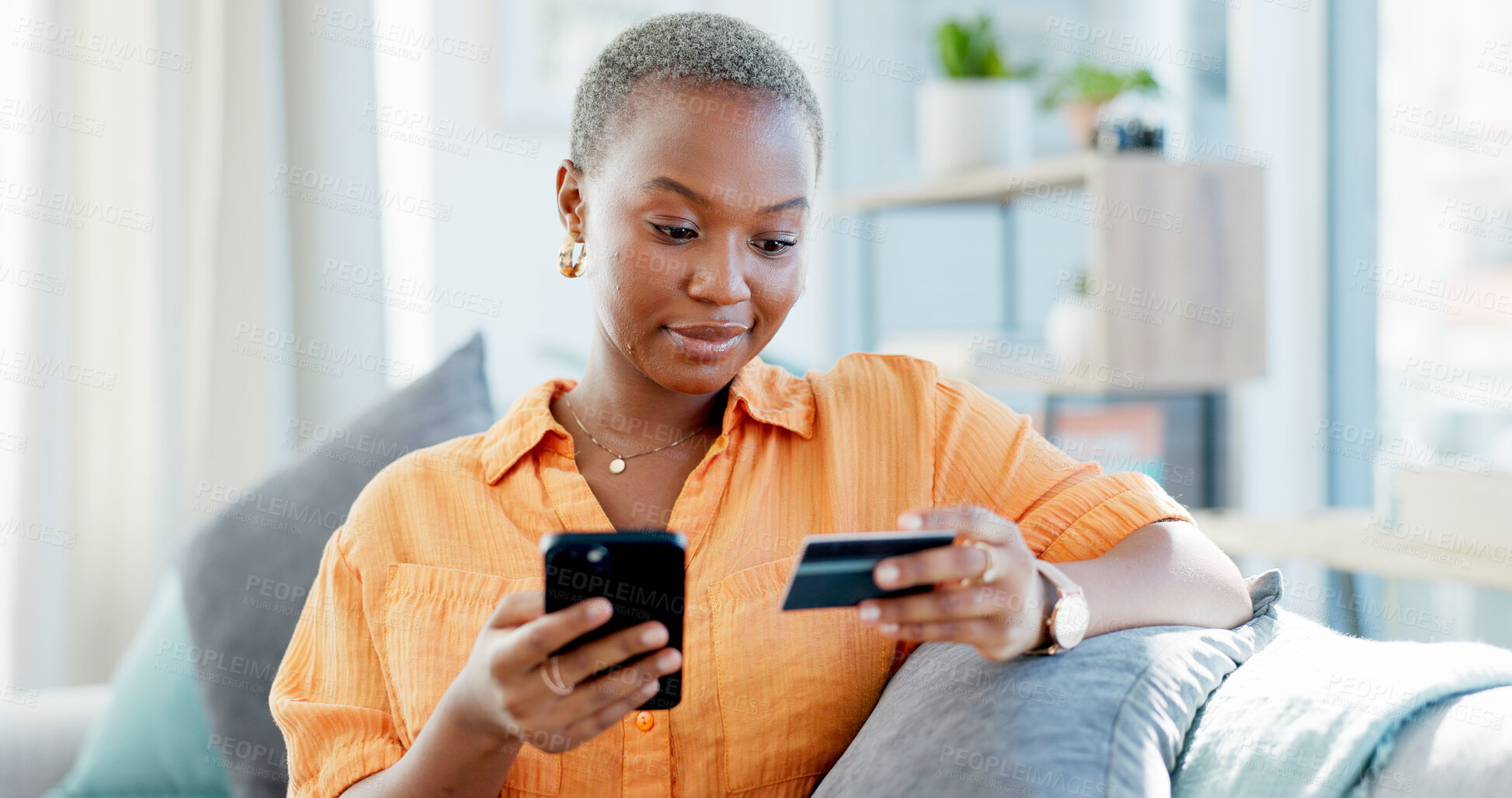 Buy stock photo Happy woman, home and online shopping with credit card, phone and payment on website in living room. Digital, purchase and black person with mobile for discount deal, ecommerce and order in house