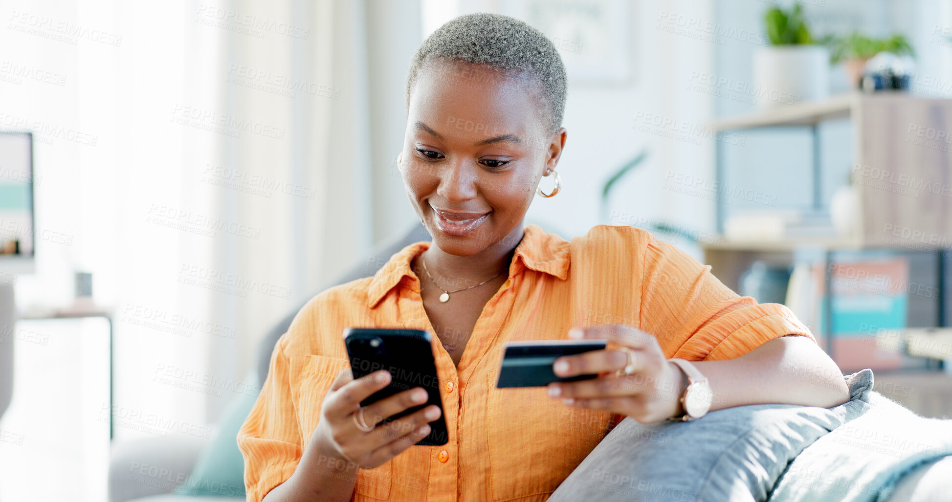 Buy stock photo Happy, black woman and phone with credit card on sofa for online shopping or banking app in home. Female person, shopper or smile with debit or smartphone for mobile payment or wireless transaction