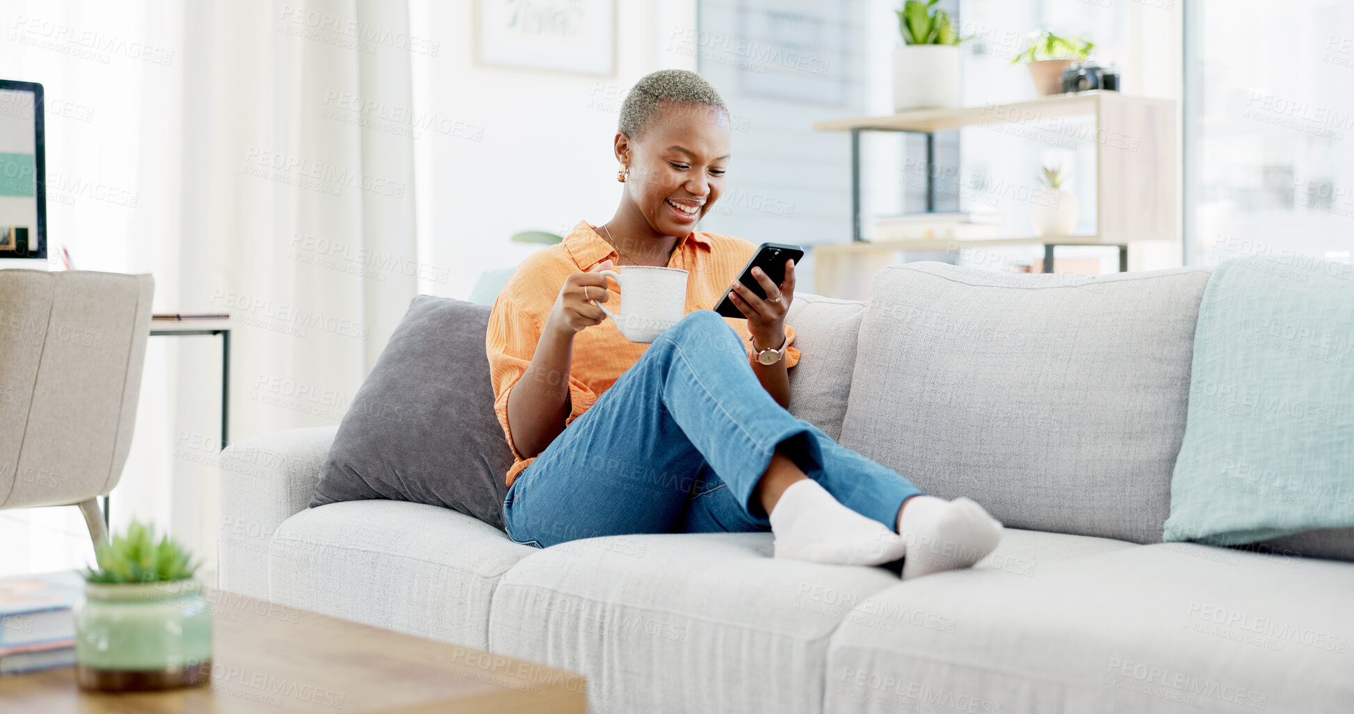Buy stock photo Phone, chat and happy woman with coffee on couch, online and laughing at message on website in house. Black person, home and reading funny post on social media, texting and smile with tea on sofa