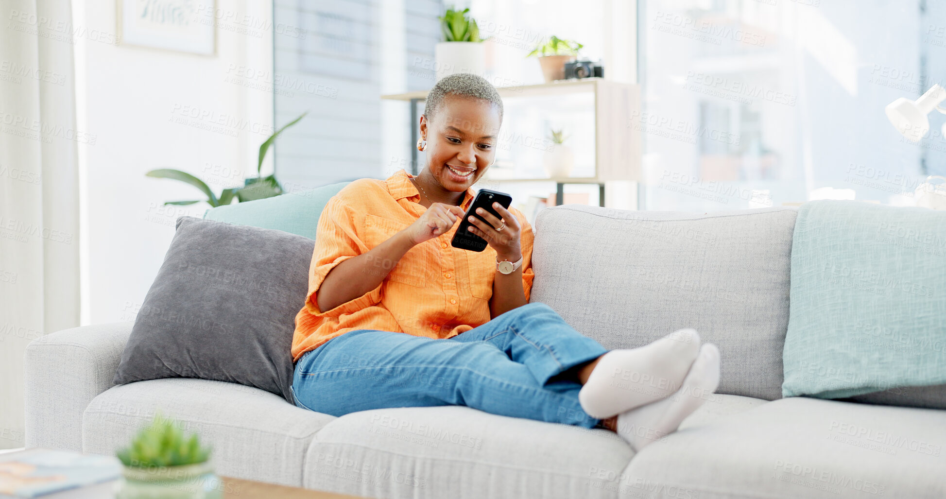Buy stock photo Scroll, online and woman with phone on couch, texting and reading message on social media in lounge. Happy, black person and chat with mobile app on sofa, home and relax with tech for communication