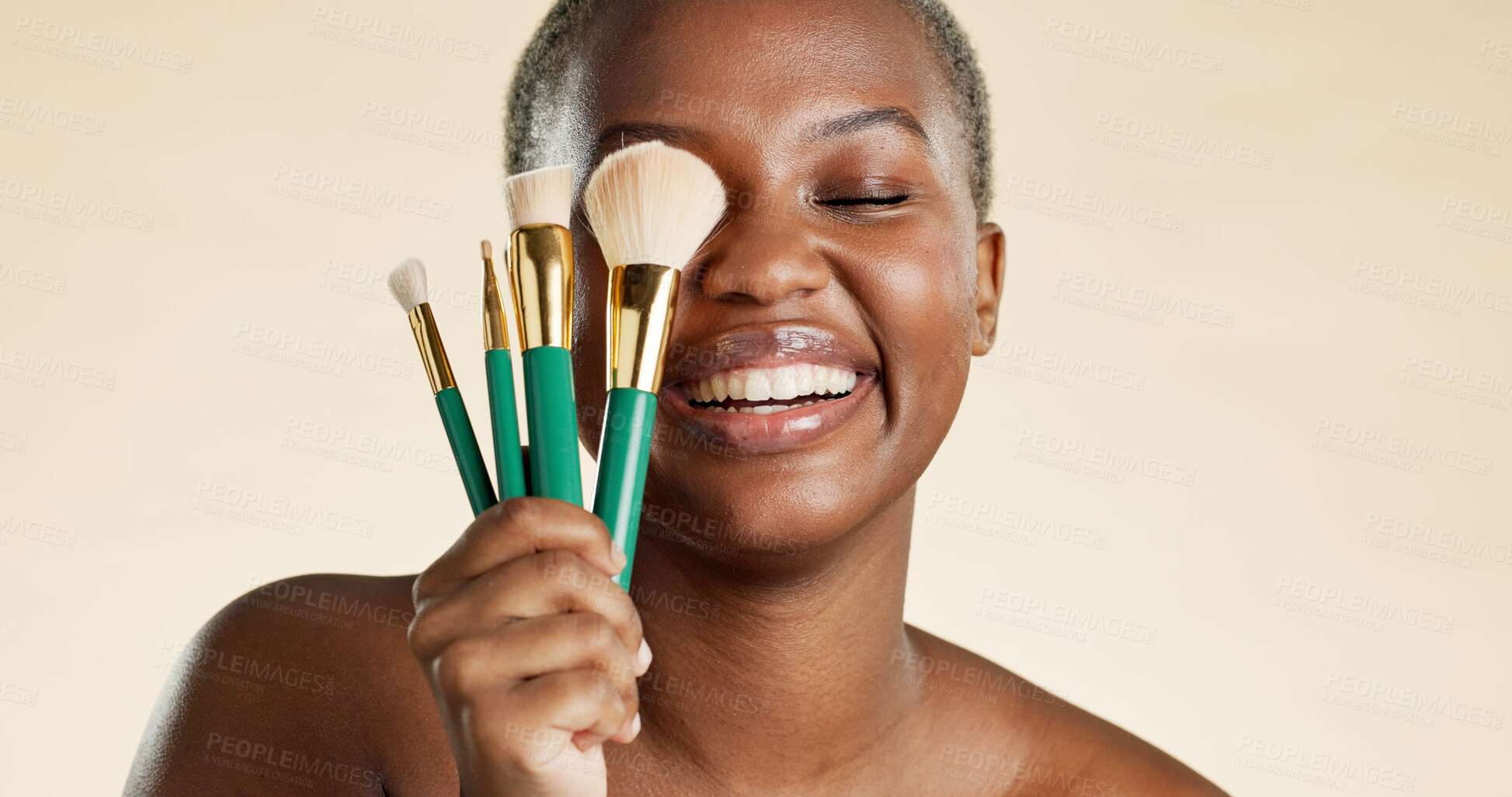 Buy stock photo Makeup, happy and woman with cosmetic brushes for beauty, natural makeover and confidence. Cosmetology, black person and laughing with tools on studio background for skincare, foundation or skin glow