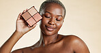 Makeup, palette and black woman with smile for foundation, highlighter and powder for beauty aesthetic. Happy, female person and cosmetic product for eyeshadow, glow and shine on studio background.