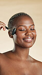 Black woman, beauty and smile with facial roller for self care, natural skincare and lymphatic drainage. Massage, glow and circulation benefits on studio background for wellness, dermatology and tool