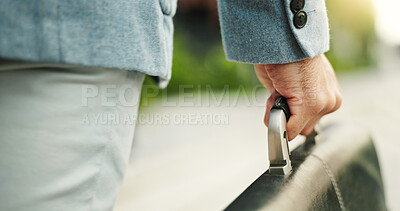 Buy stock photo Person, hands and travel with briefcase for business journey, work trip or start career on sidewalk. Businessman, traveler or carrying handle with bag for outdoor job opportunity or urban commute