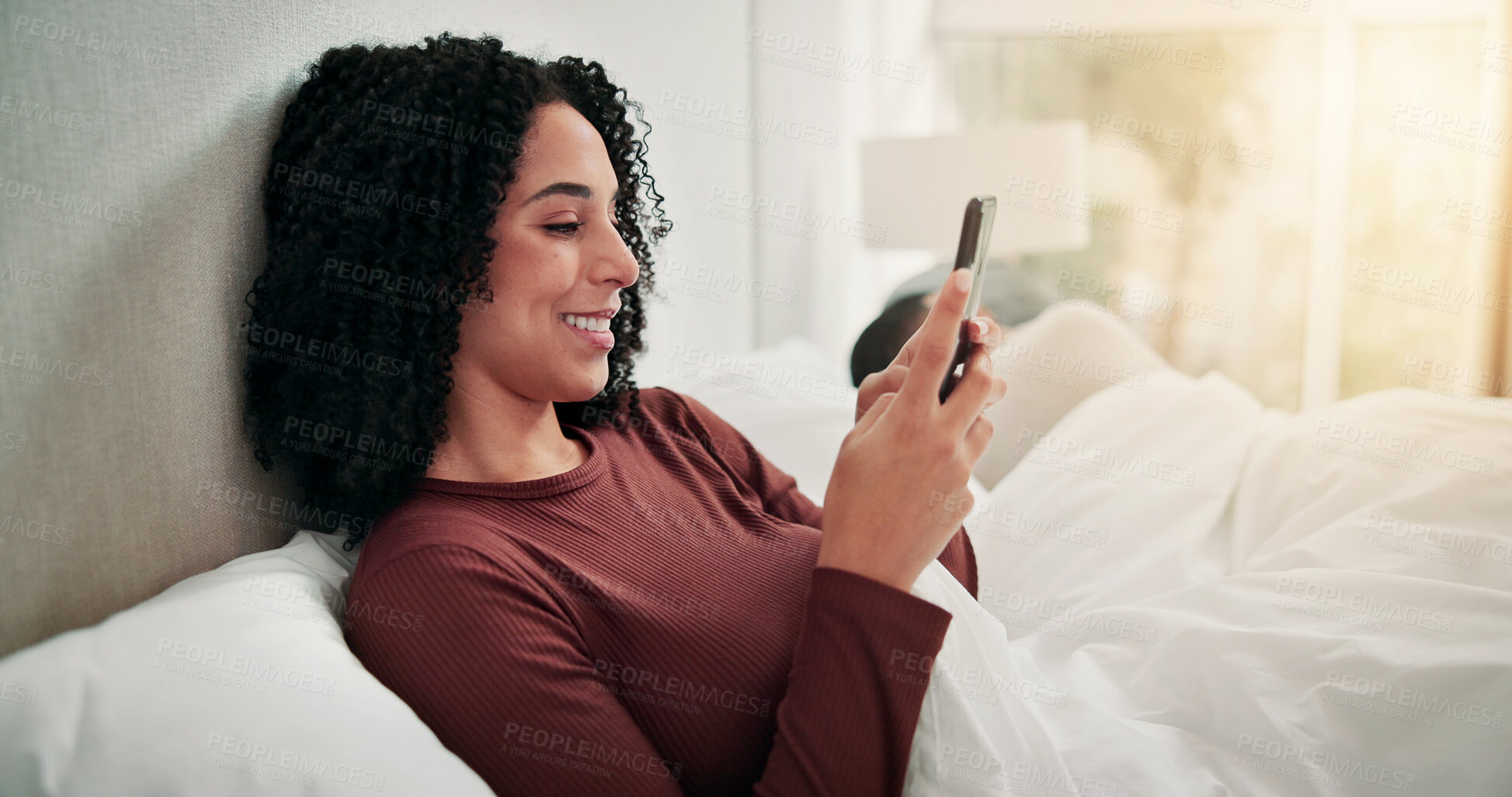 Buy stock photo Relax, couple and woman with phone in bed on weekend, reading ebook and texting for communication. Social media, message app or happy person with sleeping partner in home, mobile or browsing internet