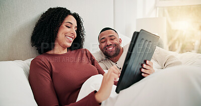 Buy stock photo Happy couple, bonding and relax in bed with tablet, movies or connection for care, blanket and break in home. Woman, man and tech with relationship, streaming or subscription on application at house
