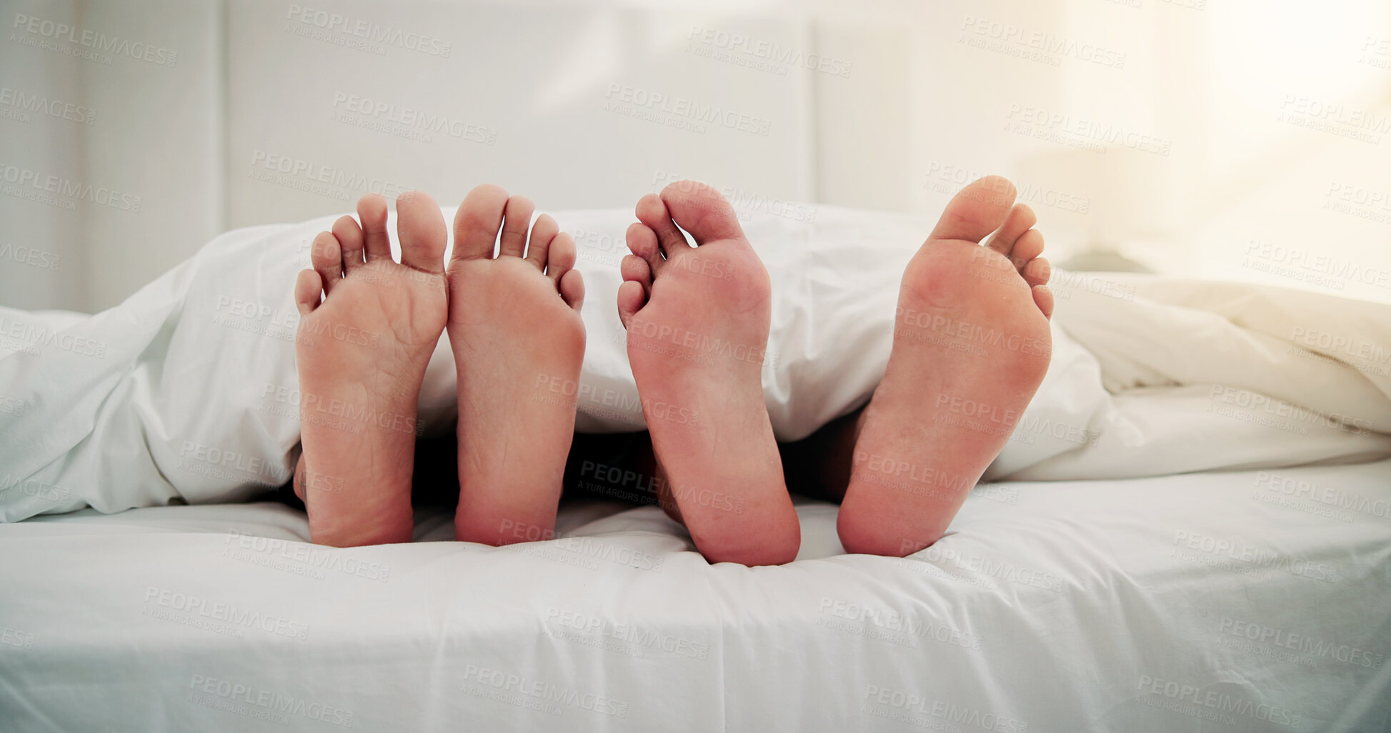 Buy stock photo Morning, sleeping and feet of couple in bed for resting, dreaming and relax together in home. Apartment, bedroom and people with blanket, duvet and barefoot for comfort, bonding and relationship