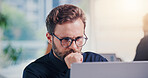 Businessman, thinking or reading in office with laptop, stock trading or review investment portfolio. Person, problem solving and monitor equity with computer, glasses or research funding opportunity