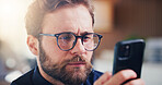 Reading, glasses and businessman with phone in office, financial advisor or communication on website. Online, chat and wealth management with mobile app, serious and person with eyewear in business