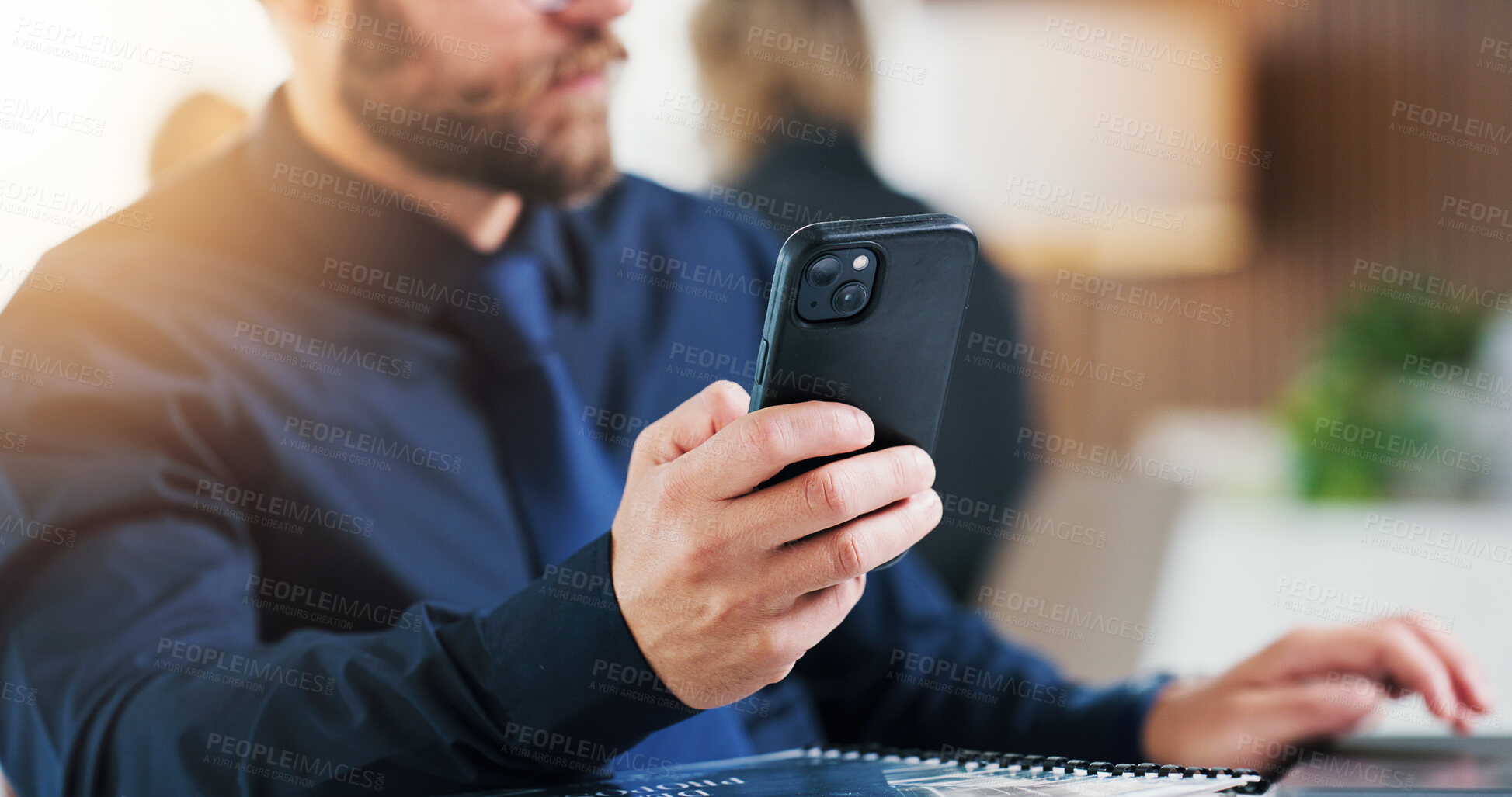 Buy stock photo Phone, hands and businessman with laptop in company for compliance info, coworking and typing. Mobile, computer and consultant in office for report, risk assessment and regulation policy development