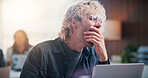 Tired, man and yawning with laptop in office for fatigue, exhausted or overworked strain. Burnout, person and employee with computer for project deadline, boredom or unproductive day in workplace