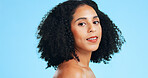 Portrait, beauty and woman in studio with space for makeover, cosmetics or natural hair for salon. Cosmetology, grooming and person with makeup, texture and health for shine, glow and blue background