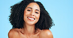 Happy, beauty and portrait of woman in studio for makeover, cosmetics and natural hair for aesthetic. Space, grooming and person with makeup, texture and health for shine, glow and blue background