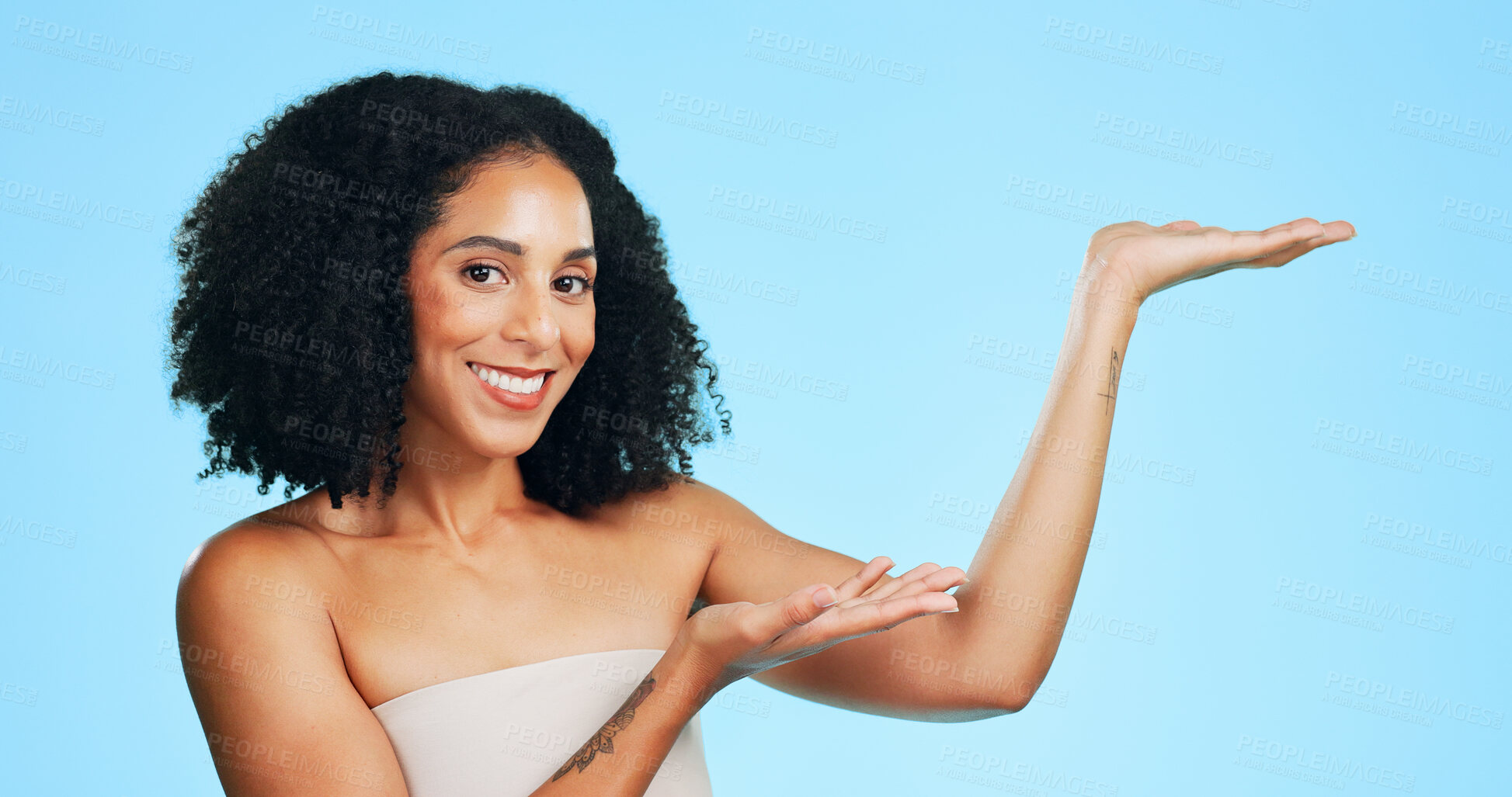 Buy stock photo Portrait, skincare and woman with presentation in studio,  beauty and product placement for launch. Smile, dermatology and person with promotion for glowing skin, natural aesthetic or blue background