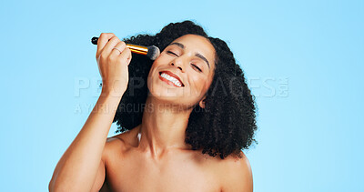 Buy stock photo Beauty, happiness or woman in studio with brush, coverage or blending in makeup routine. Cosmetology, smile or person on blue background with tools, makeover or flawless application for glow.