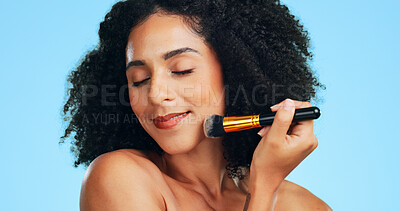 Buy stock photo Makeup, smile or woman in studio with brush, coverage or blending in beauty routine. Cosmetology, happy or female person on blue background with tools, makeover or flawless application for glow.