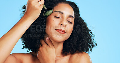 Buy stock photo Woman, skincare or jade roller in studio with massage, beauty tools or lymphatic drainage benefits. Person, relax and facial product for blood circulation, dermatology or cosmetics on blue background