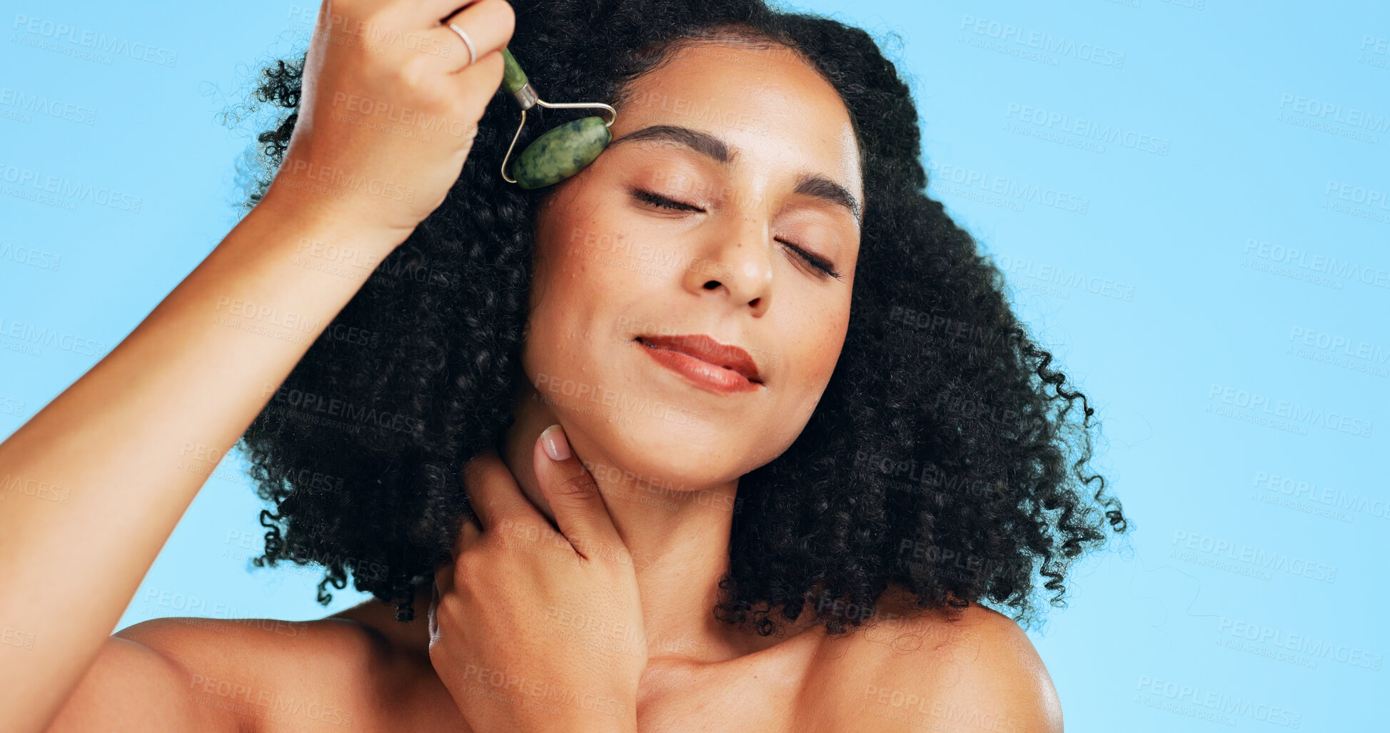 Buy stock photo Woman, skincare or jade roller in studio with massage, beauty tools or lymphatic drainage benefits. Person, relax and facial product for blood circulation, dermatology or cosmetics on blue background