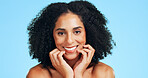 Portrait, skincare and happy woman in studio for dermatology, shine and wellness on blue background. Cosmetic, smile and person with facial glow for beauty, aesthetic benefits and smooth skin