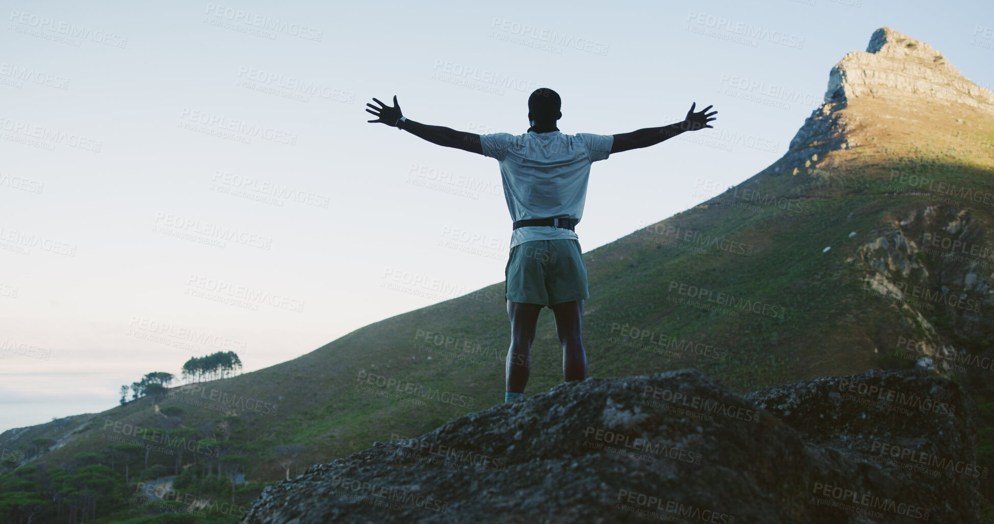 Buy stock photo Hiking, back and man on cliff with arms up, cardio goal or celebration in fitness activity. Training, space or male person on mountain with victory, achievement or milestone reach in outdoor trekking