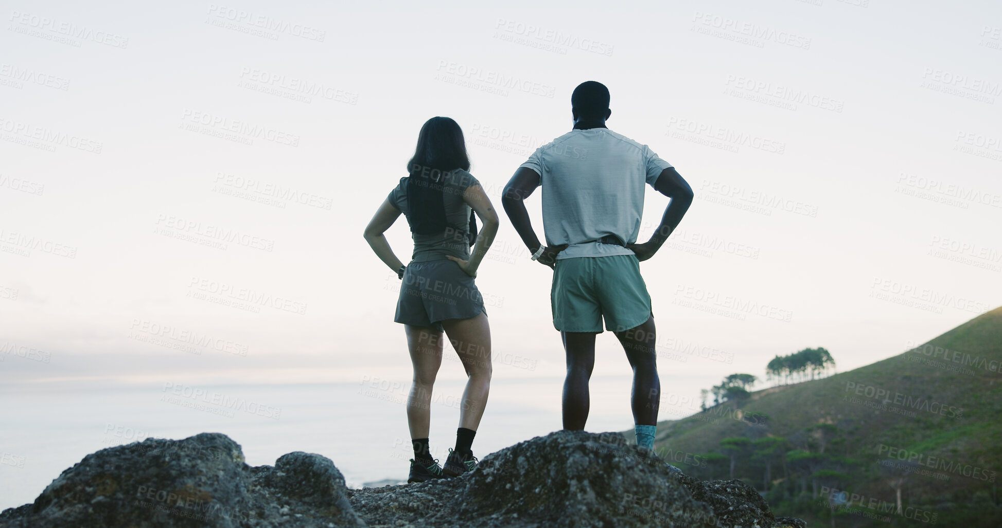 Buy stock photo Back, couple and hiking for fitness on hill for travel, adventure and ocean view on holiday. Space, people and trekking mountain for sightseeing sea, explore nature and fresh air on getaway vacation
