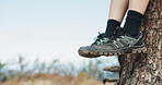 Relax, sneakers and hiking with person outdoor in nature for adventure, fitness or sports hobby. Blue sky space, break and feet with hiker in forest for journey, rest or scenic view of environment