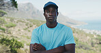 Outdoor, portrait and black man with arms crossed for fitness, travel and hiking hobby for exercise. Serious, nature and person with pride for trekking adventure, explore mountain and aerobic workout