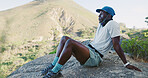 Break, fitness and black man on mountain for hiking, exercise or health in nature for breathing. Fatigue, active and African person with rest for trekking outdoor with challenge and wellness.